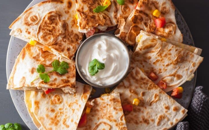 Overhead image of slices of a chicken quesadilla on a plate