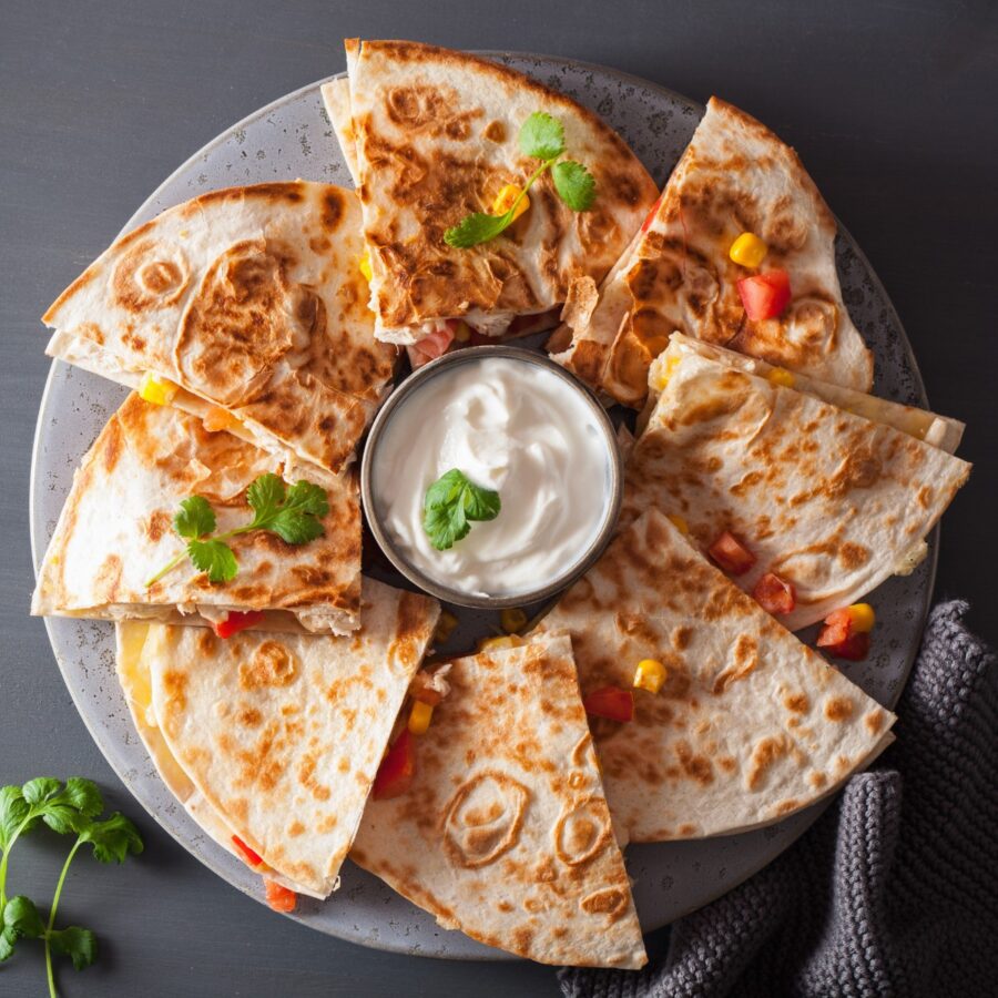 Overhead image of slices of a chicken quesadilla on a plate