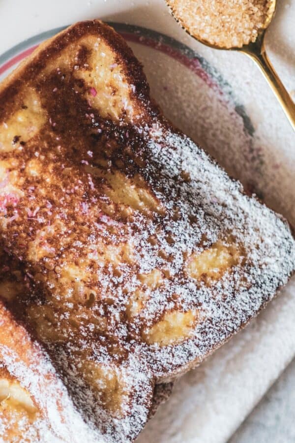 Close up image of Cinnamon French Toast on a plate sprinkled with powdered sugar