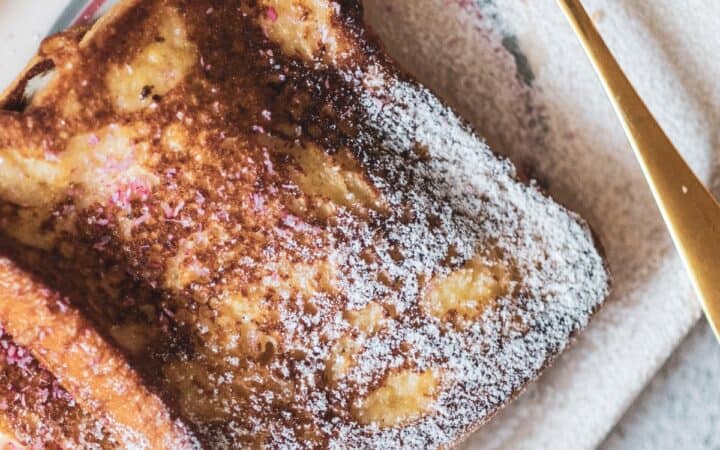 Close up image of Cinnamon French Toast on a plate sprinkled with powdered sugar