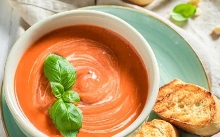 Overhead image of Creamy Tomato Soup in a bowl with toasted bread