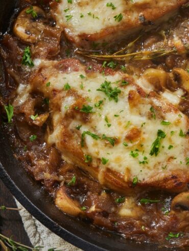 Close up image of French Onion Pork Chops in a skillet