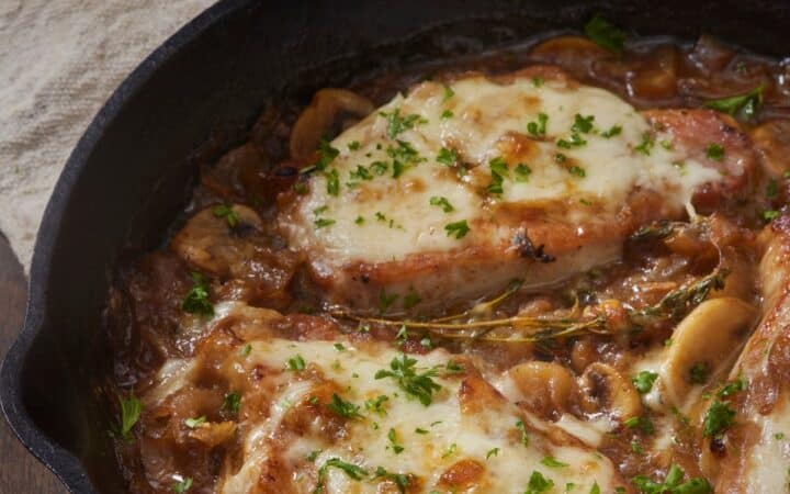 Overhead image of French onion pork chops in a skillet