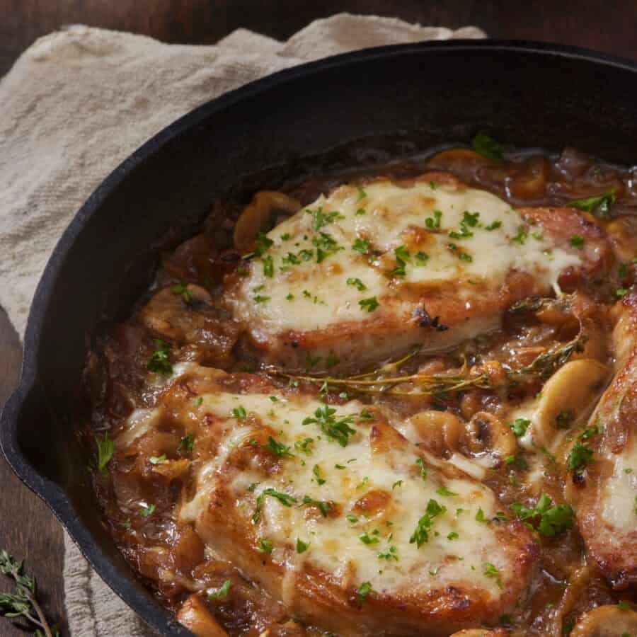 Overhead image of French onion pork chops in a skillet