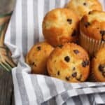 Close up image of Mini Muffins in a wicker basket lined with a towel