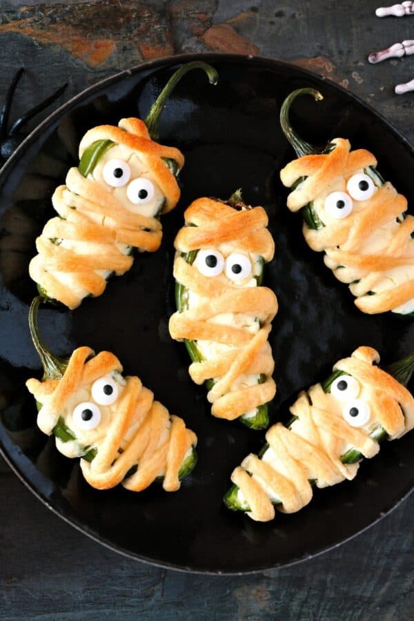 Overhead image of Mummy Jalapeno Poppers on a white plate