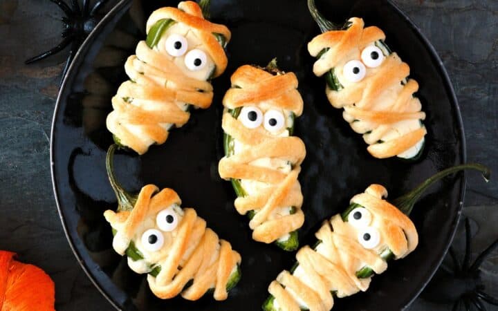 Overhead image of Mummy Jalapeno Poppers on a white plate