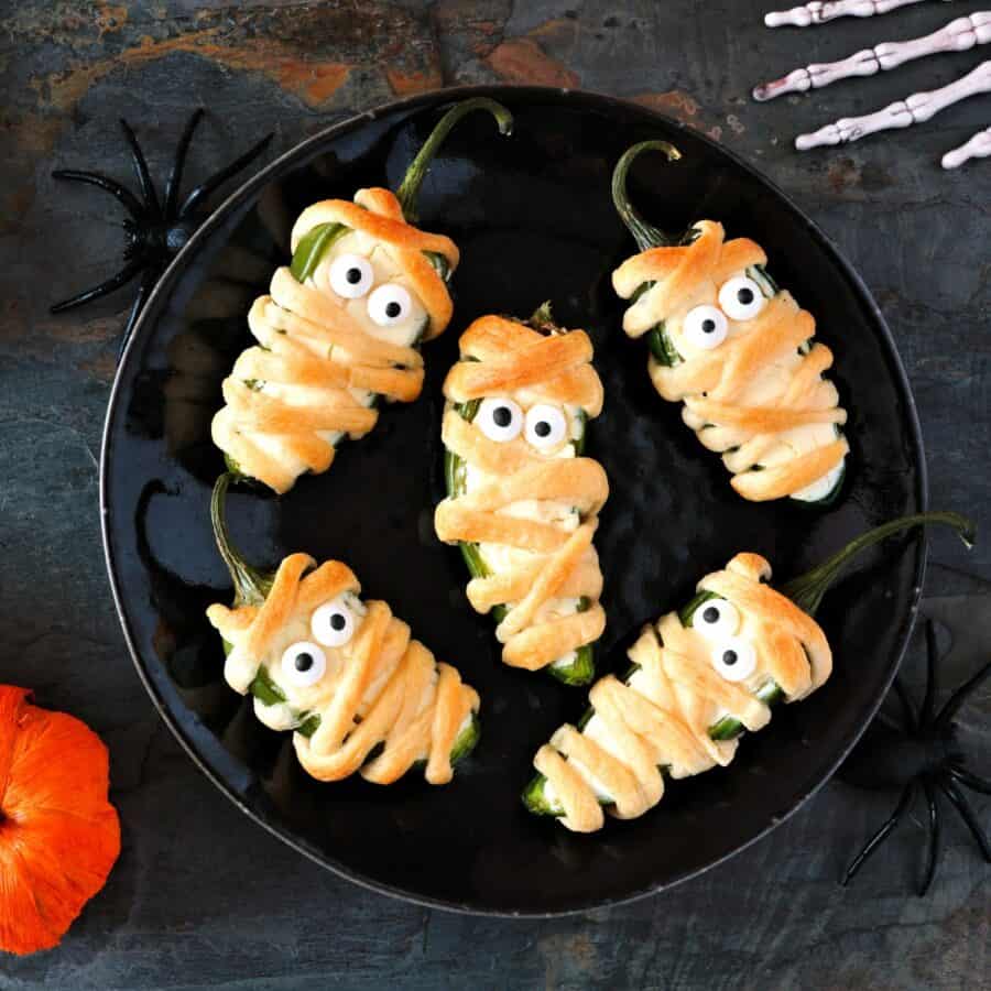 Overhead image of Mummy Jalapeno Poppers on a white plate