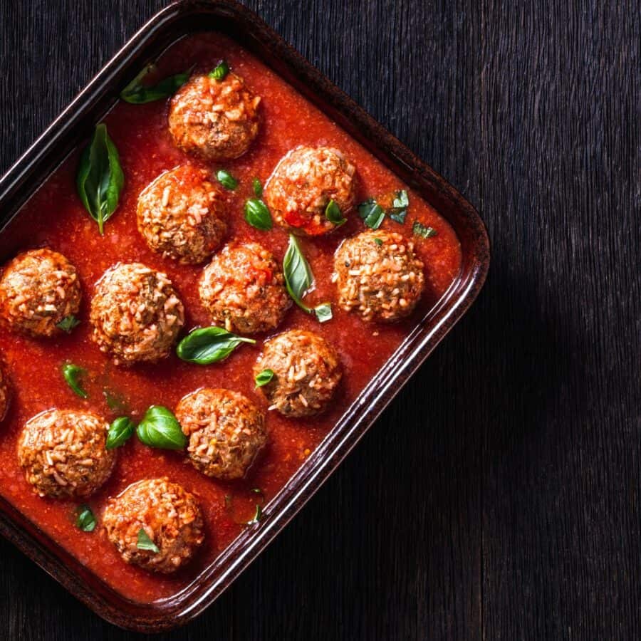 Overhead image of Porcupine Meatballs in a dish with tomato sauce