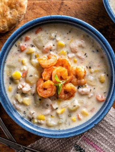 Overhead image of Shrimp and Corn Soup in a blue bowl