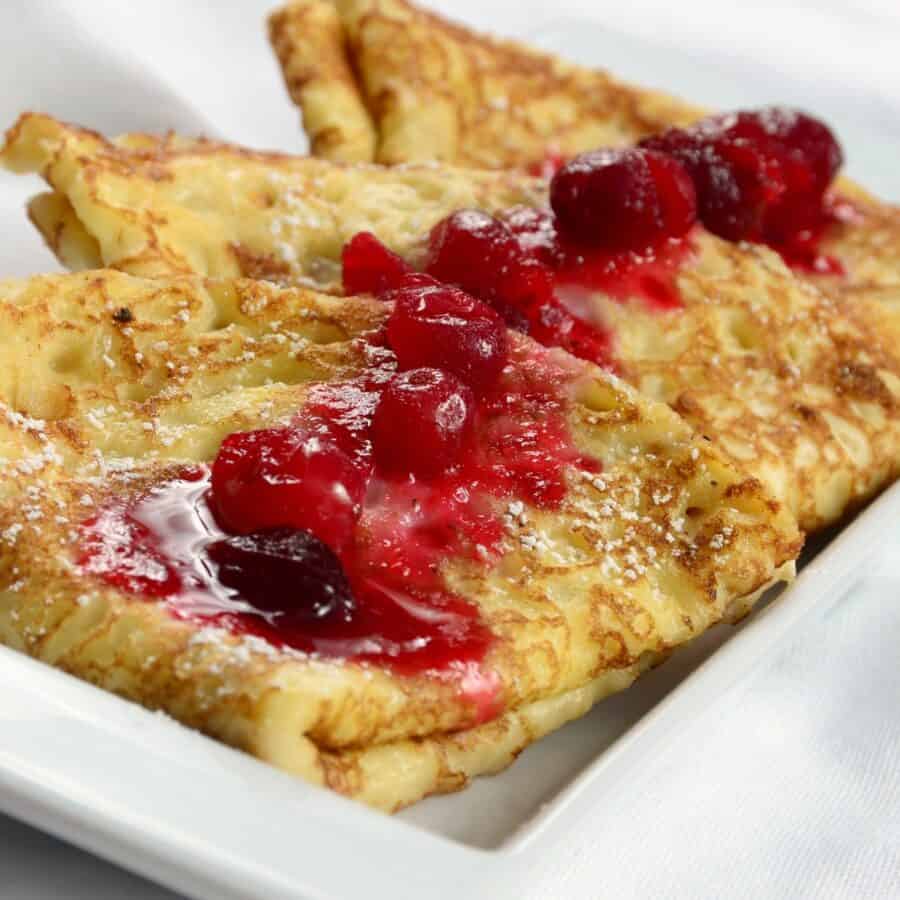 Close up image of Swedish Pancakes with ligonberry jam on top