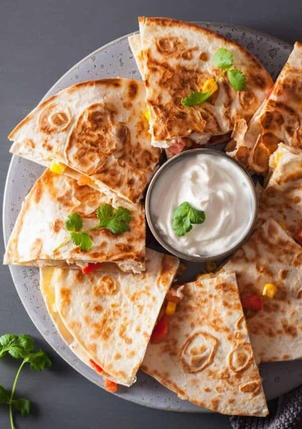 Overhead image of slices of a chicken quesadilla on a plate