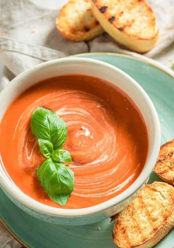 Overhead image of Creamy Tomato Soup in a bowl with toasted bread