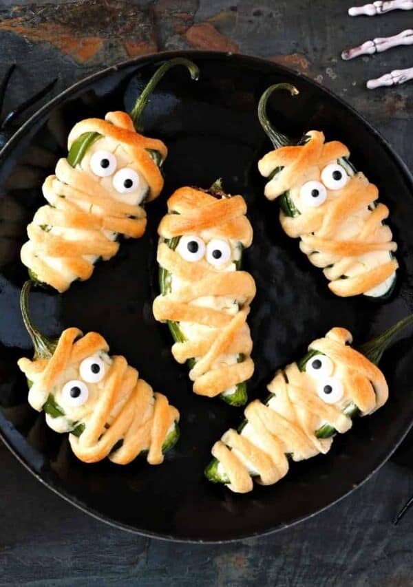 Overhead image of Mummy Jalapeno Poppers on a white plate