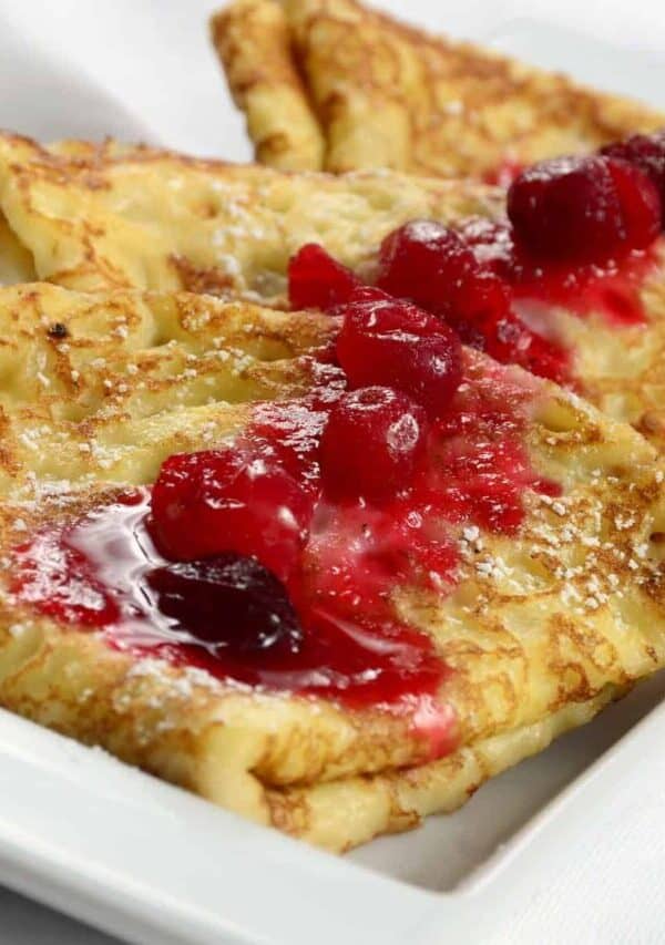 Close up image of Swedish Pancakes with ligonberry jam on top