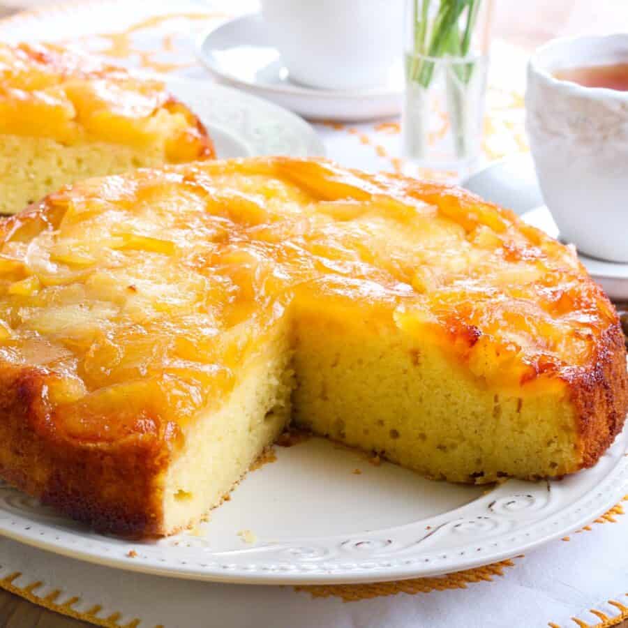 Close up image of an Apple Upside Down Cake with a slice cut out of it