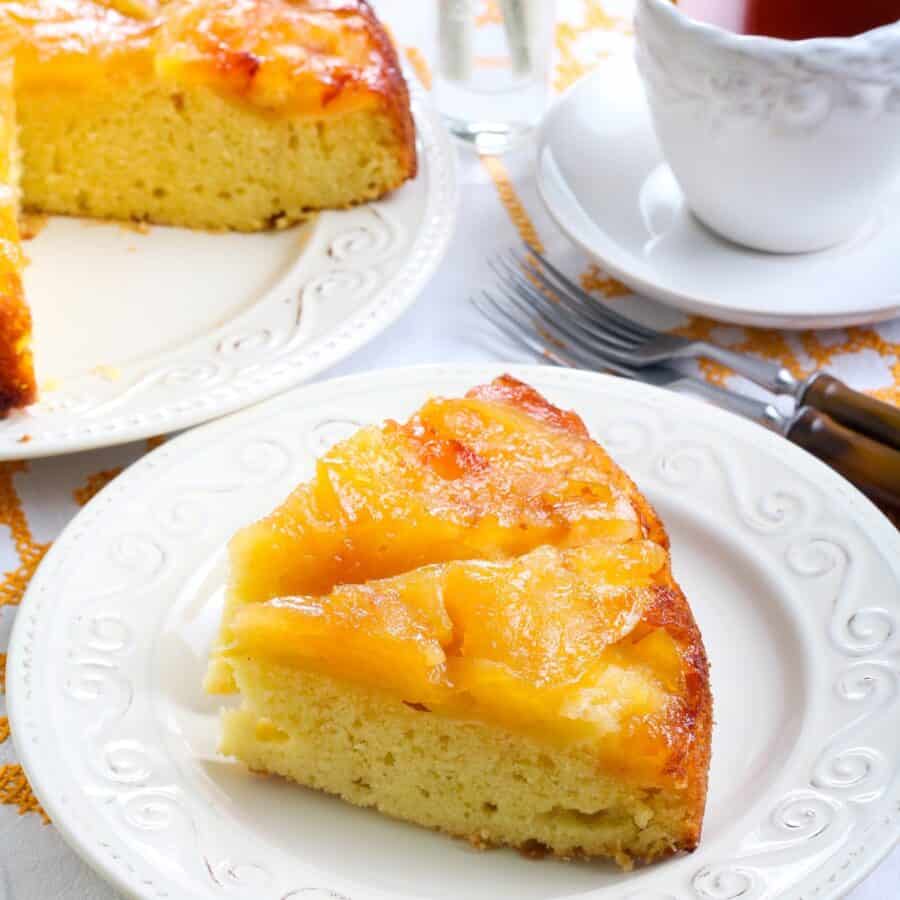 Two pieces of Apple Upside Down Cake on a white plate