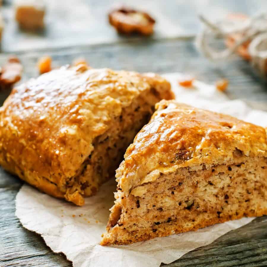 Two pumpkin scones on parchment paper