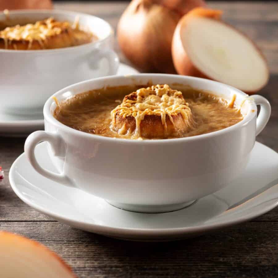 Close up image of Slow Cooker French Onion Soup in a white bowl