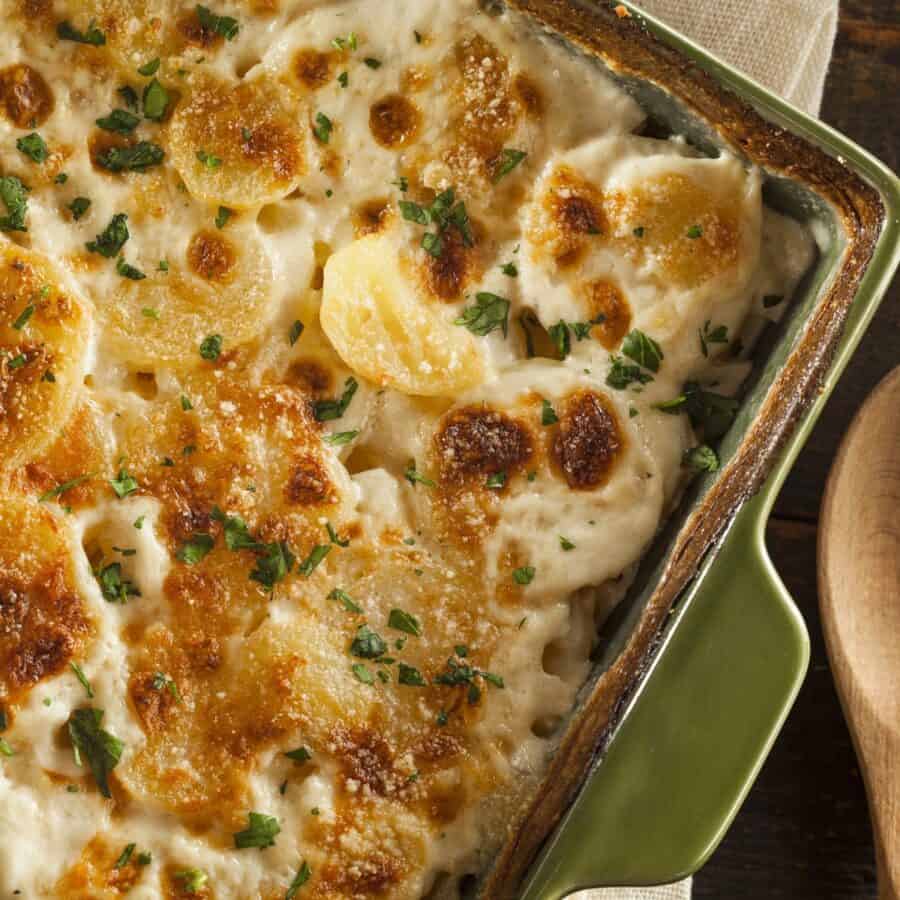 Overhead image of Slow Cooker Scalloped Potatoes in a green baking dish