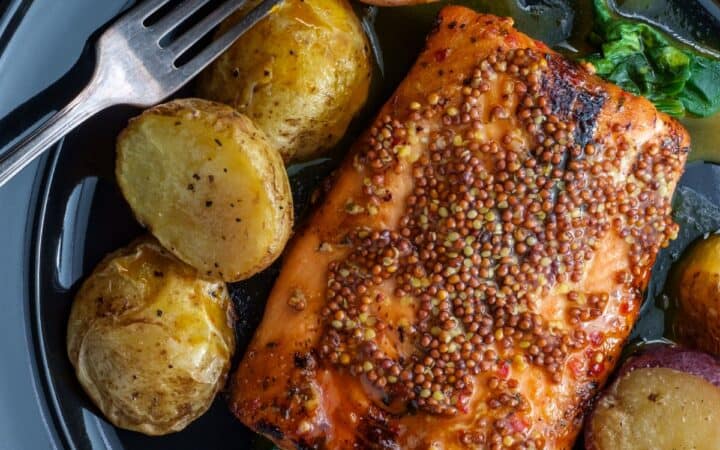 Overhead image of Dijon Salmon on a plate with baby potatoes and greens