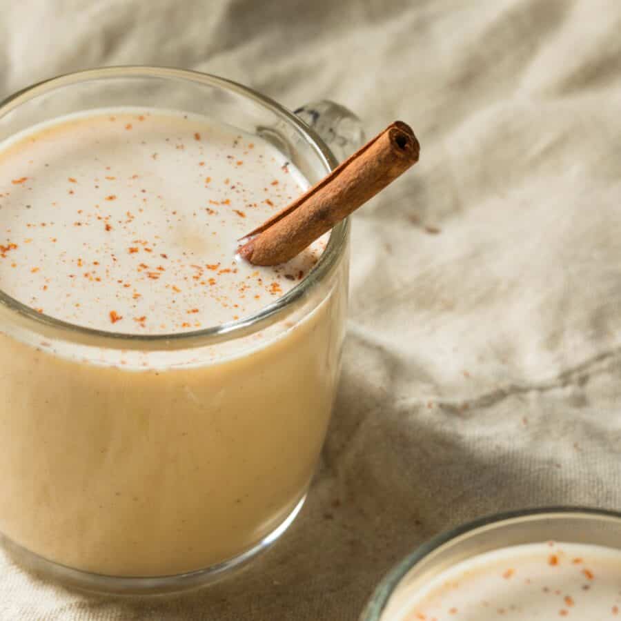 image of a mug of Eggnog with a cinnamon stick in it