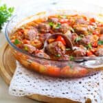 Hawaiian meatballs in a glass bowl being served with a spoon - 8