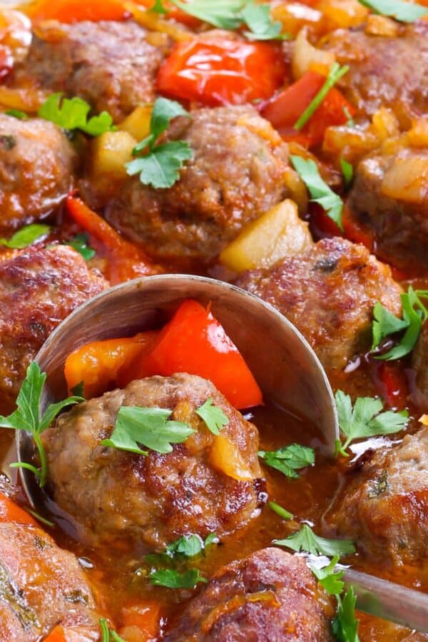 Close up image of Hawaiian Meatballs with a serving spoon