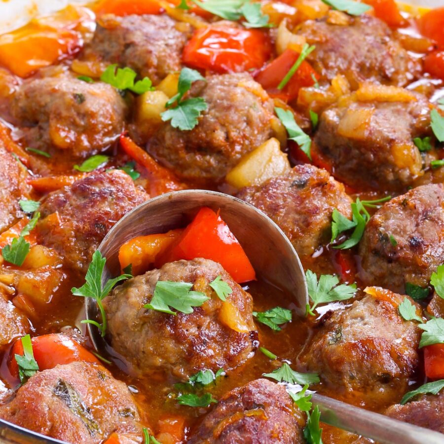 Close up image of Hawaiian Meatballs with a serving spoon