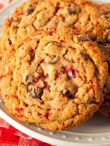 Close up image of peppermint chocolate chip cookies on a white plate