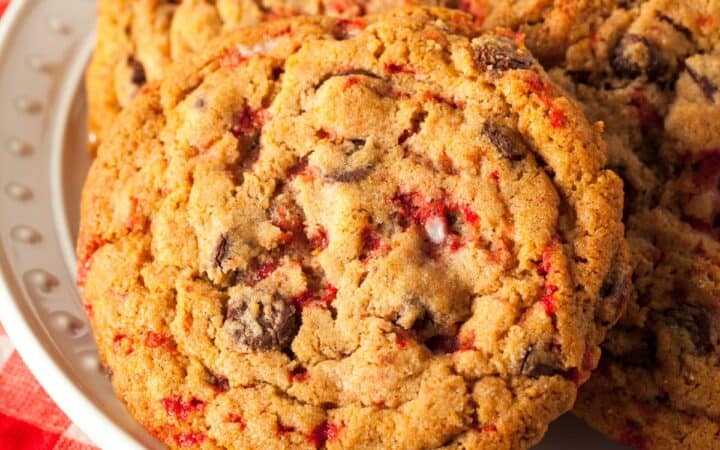 Close up image of peppermint chocolate chip cookies on a white plate