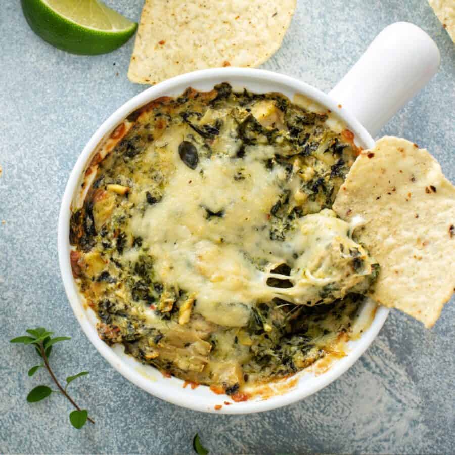 Overhead image of Crock Pot Spinach Artichoke Dip in a white crock