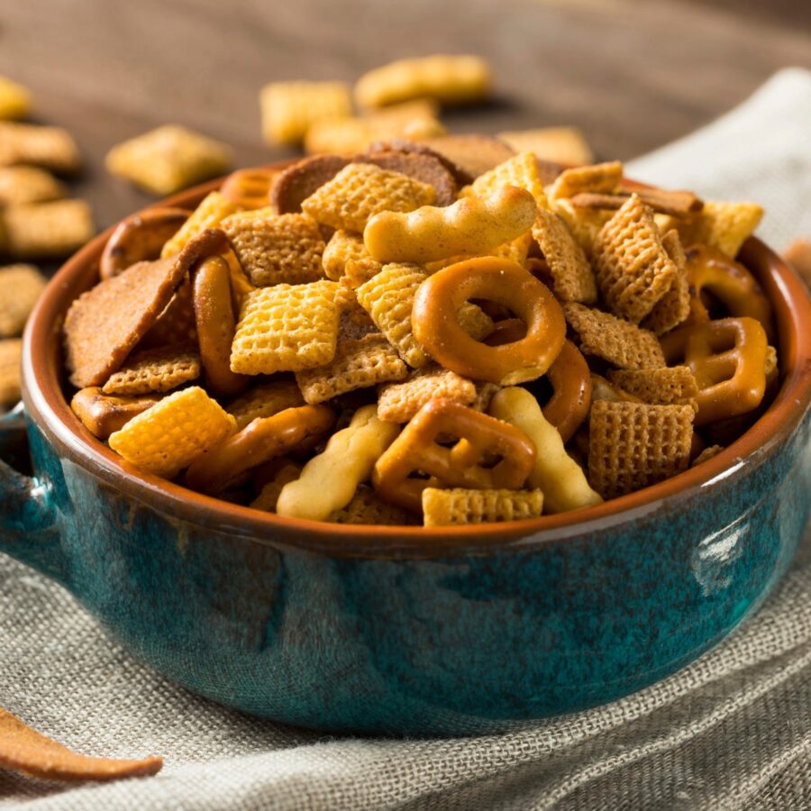 Close up image of Spicy Chex Mix in a teal bowl