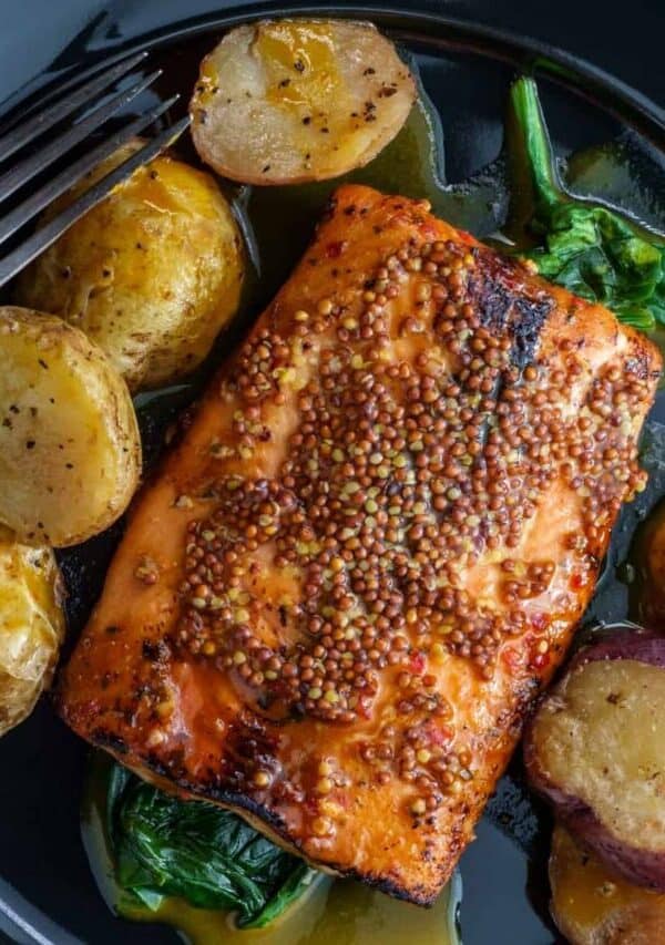 Overhead image of Dijon Salmon on a plate with baby potatoes and greens