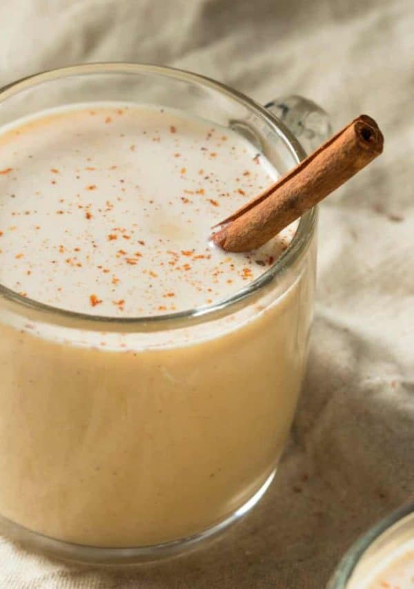 image of a mug of Eggnog with a cinnamon stick in it