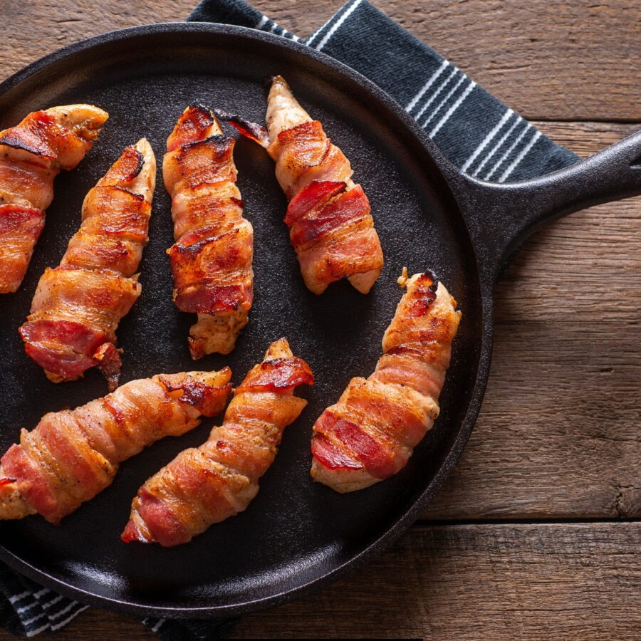 Overhead image of Bacon Wrapped Chicken Tenders in a cast iron skillet