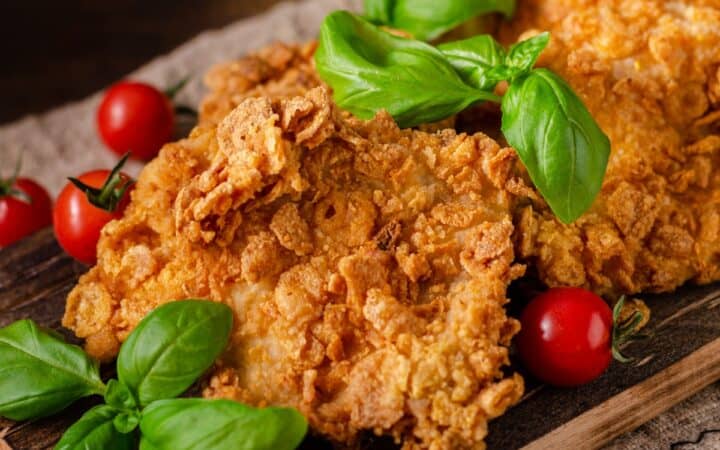 Close up image of cornflake chicken on a sheet pan