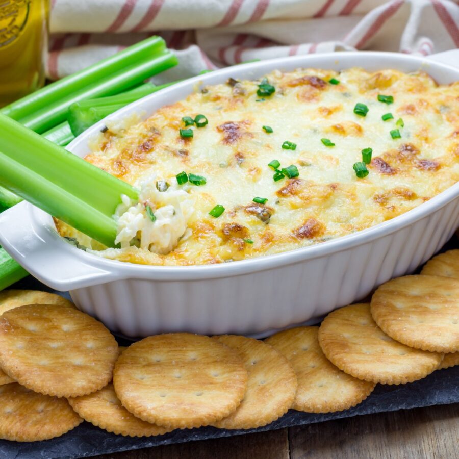 Close up image of Hot Maryland Crab Dip being served with crackers and celery