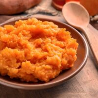 Close up image of mashed sweet potatoes in a bowl