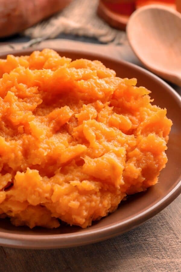 Close up image of mashed sweet potatoes in a bowl