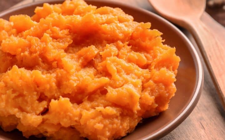 Close up image of mashed sweet potatoes in a bowl