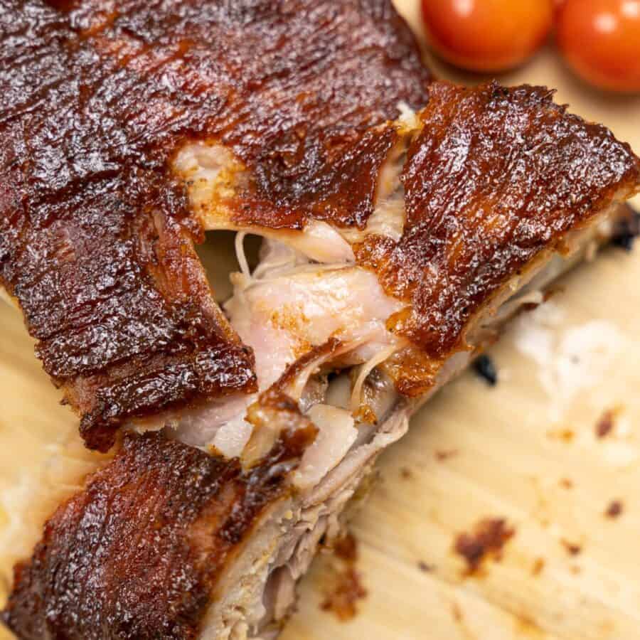 A slab of Baked Pork RIbs with one sliced off of the end