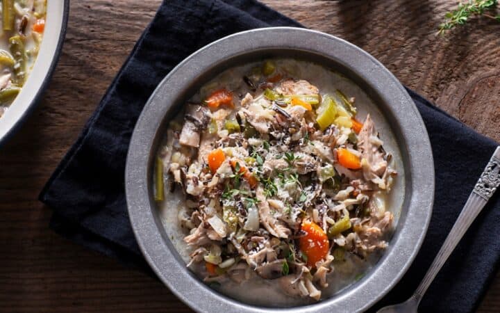 Turkey And Wild Rice Soup in a bowl on a wooden table