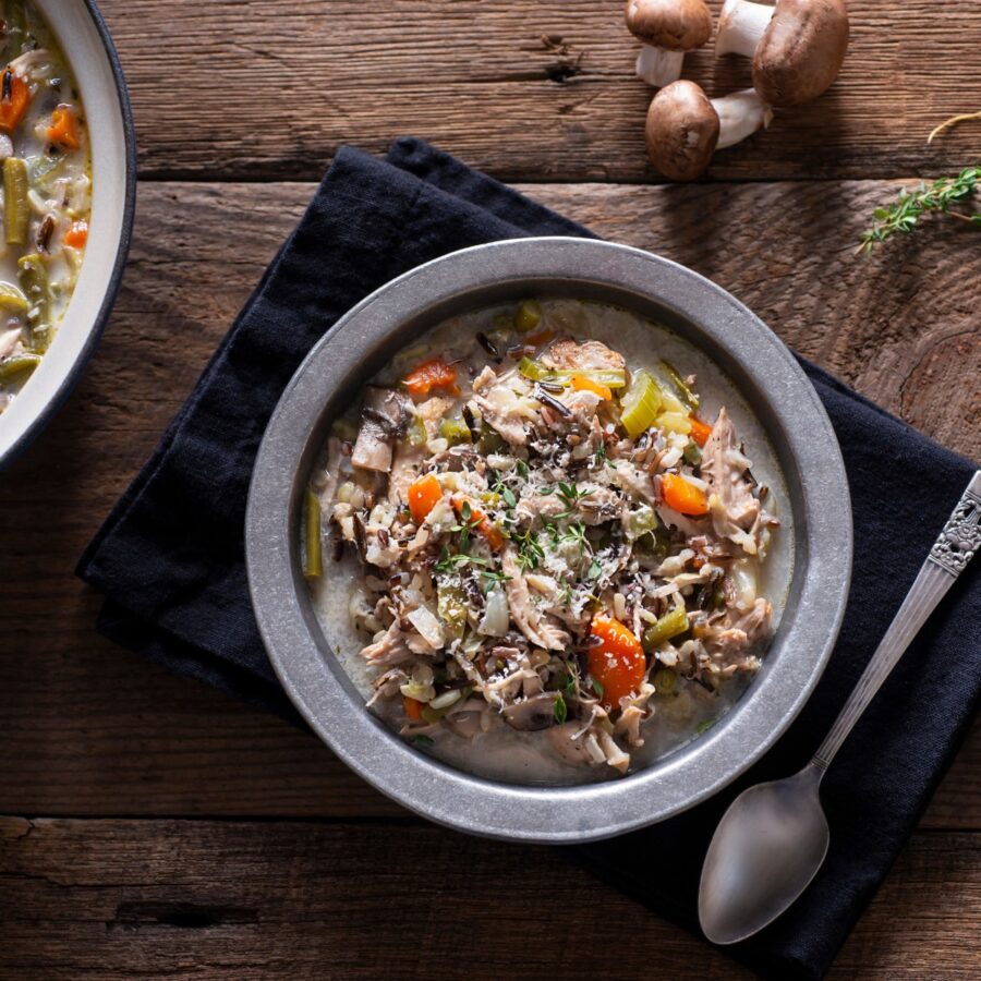 Turkey And Wild Rice Soup in a bowl on a wooden table