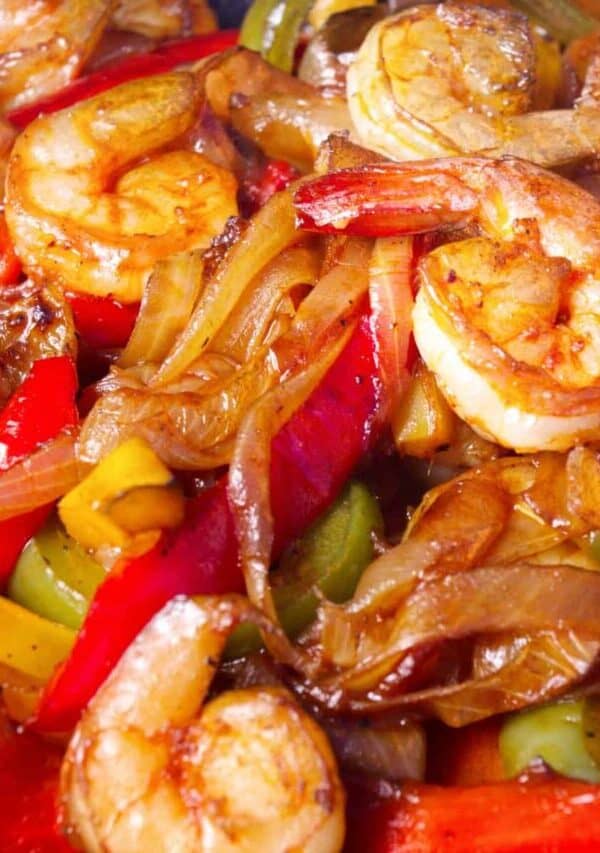 Image of roasted onions, peppers, and shrimp to fill Sheet Pan Shrimp Fajitas