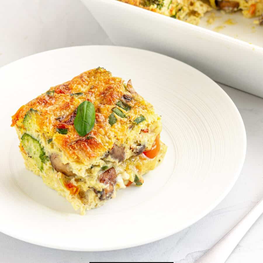 A piece of the best breakfast casserole on a white plate