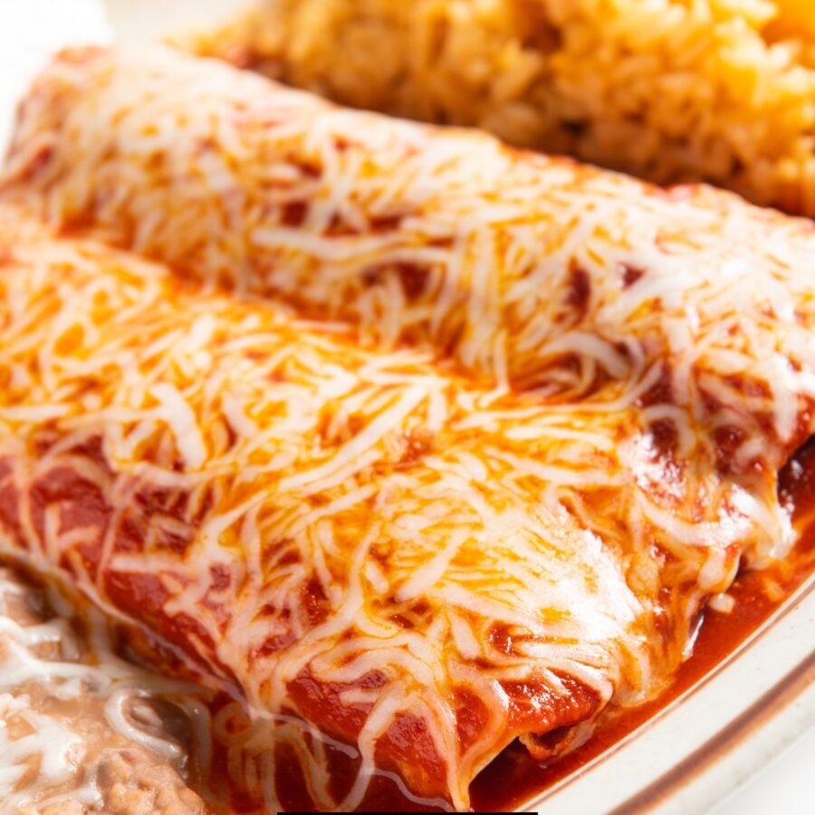 Close up image of Black Bean Enchiladas on a plate with rice and beans