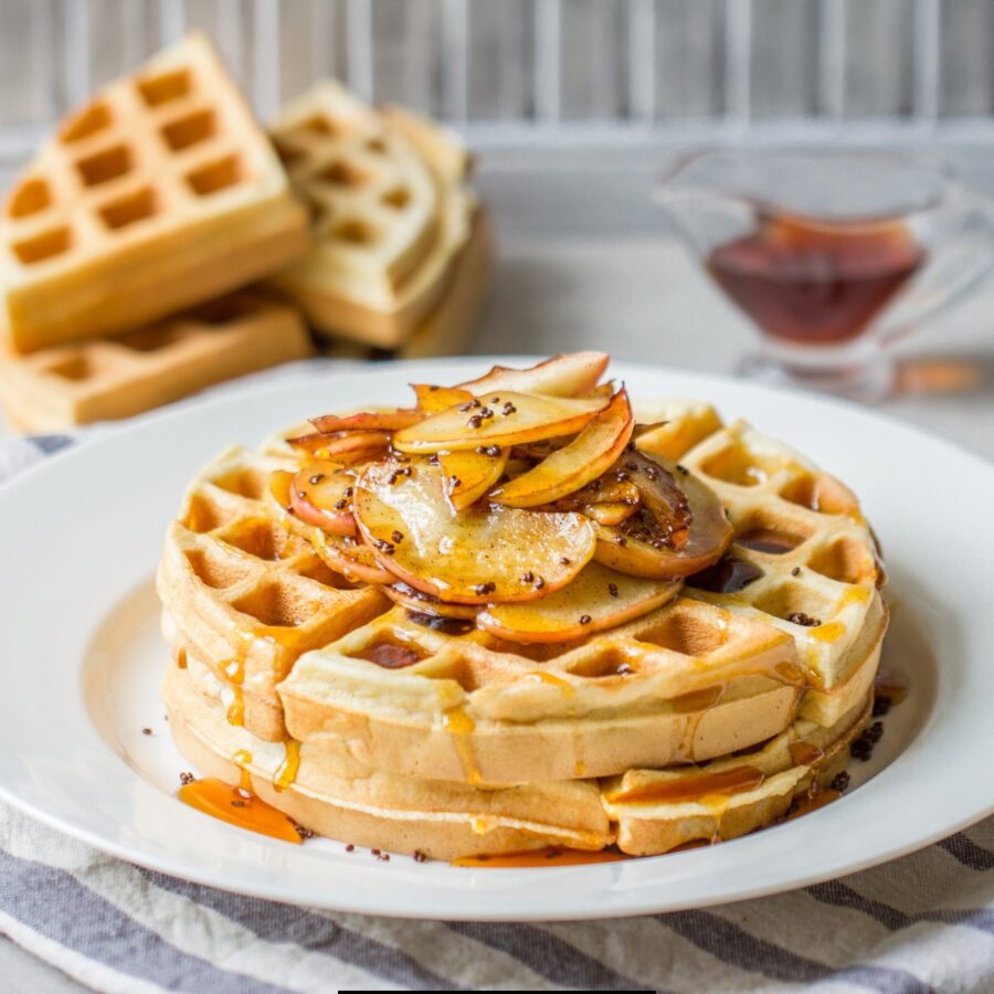 Buttermilk Waffles on a plate with sliced apples