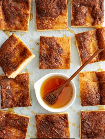 Overhead image of Cheesecake Bars with a bowl of honey in the middle