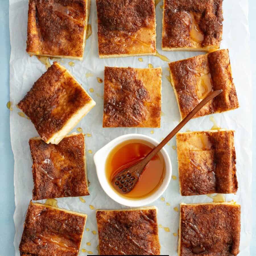 Overhead image of Cheesecake Bars with a bowl of honey in the middle